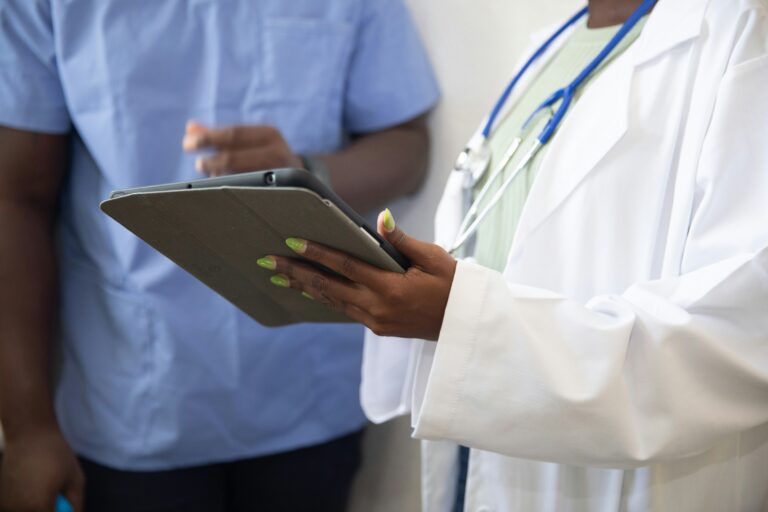 Clinicians reviewing patient information on a tablet